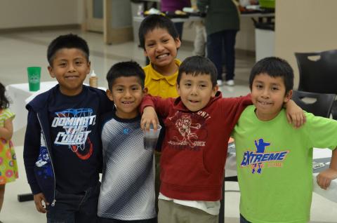 Childrend with arms around each other